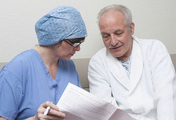A surgeon informing a patient