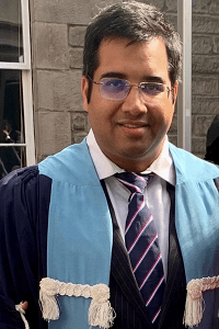 abjiheet beniwal stands at graduation, a head and shoulders photo