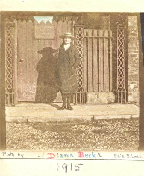 Sepia-tinted portrait of Diana Beck as a schoolgirl in front of a gate