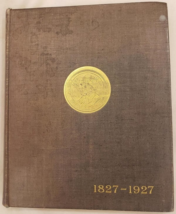 The front cover of a brown cloth-covered hardcover book, with a gold foil stamp containing an engraved portrait and the words "Lord Lister", and dated "1827-1927".