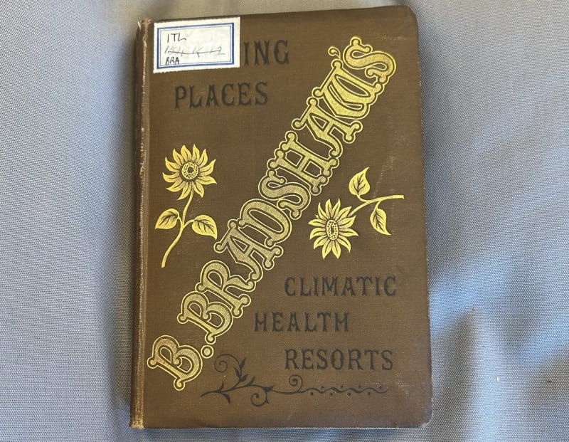 A brown fabric book cover reading 'B. Bradshaw's Bathing Places Climatic Health Resorts'