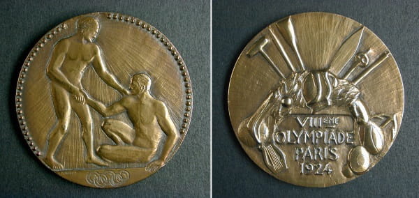 Bronze medal, the obverse shows a one man helping another to his feet, the reverse shows a collection of sports equipment and the words 'VIII-eme Olypiade Paris 1924'